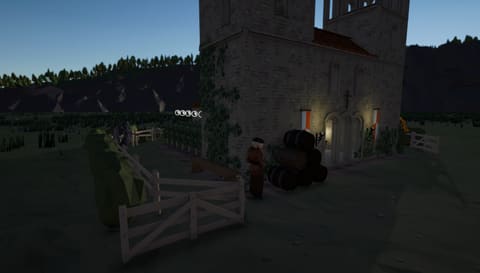A monk stands by wine barrels at the lantern-lit church door at dusk